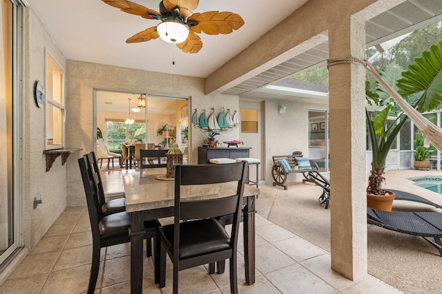 carpeted dining area with ceiling fan