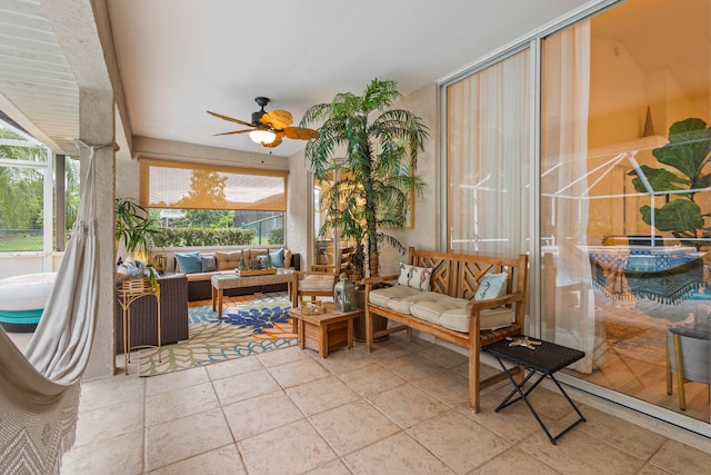 sunroom / solarium featuring ceiling fan