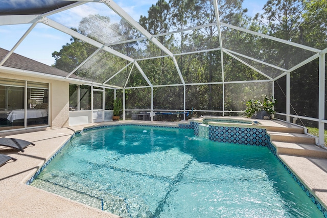 view of pool with a patio, an in ground hot tub, and glass enclosure