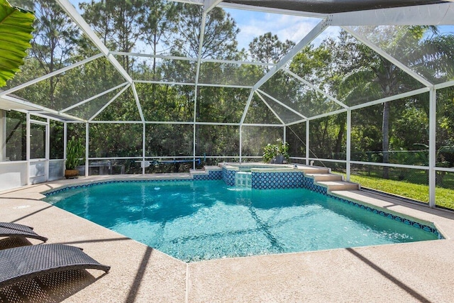 view of swimming pool with an in ground hot tub, a patio, and glass enclosure