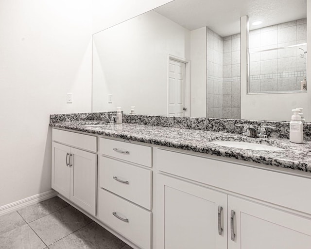 bathroom featuring tile patterned floors, vanity, and a shower