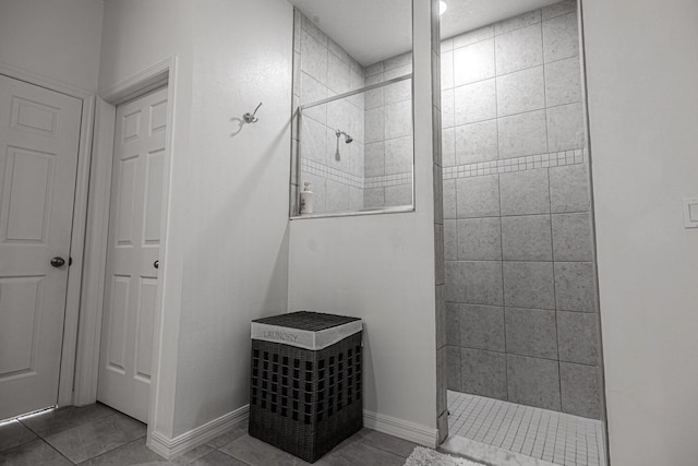 bathroom with tile patterned floors and a tile shower