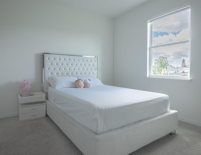 carpeted bedroom featuring multiple windows