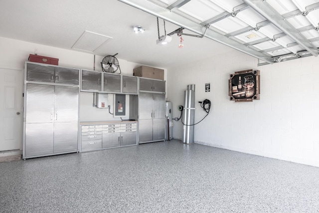 garage featuring electric panel and a garage door opener