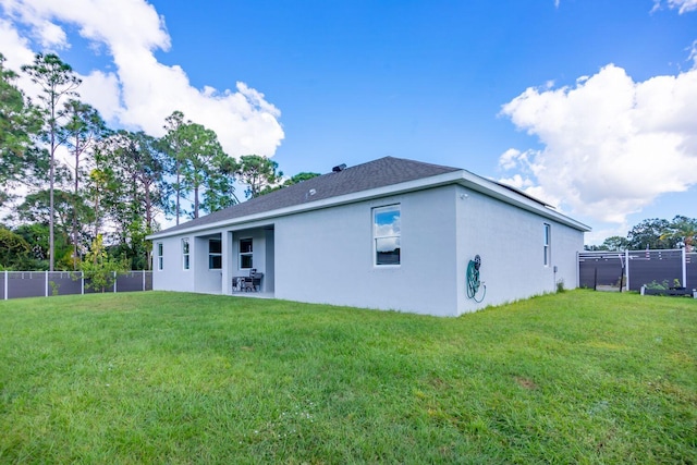 rear view of property with a lawn