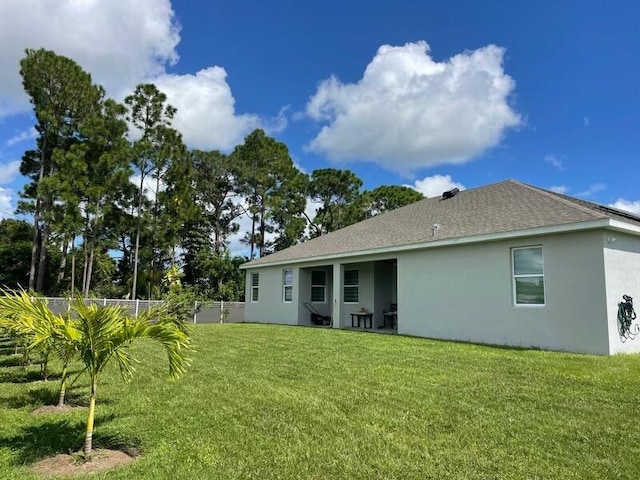 rear view of property with a yard