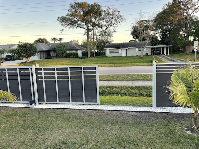 gate at dusk with a yard