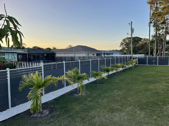 view of yard at dusk