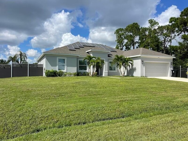 view of front of property featuring solar panels, a garage, and a front yard