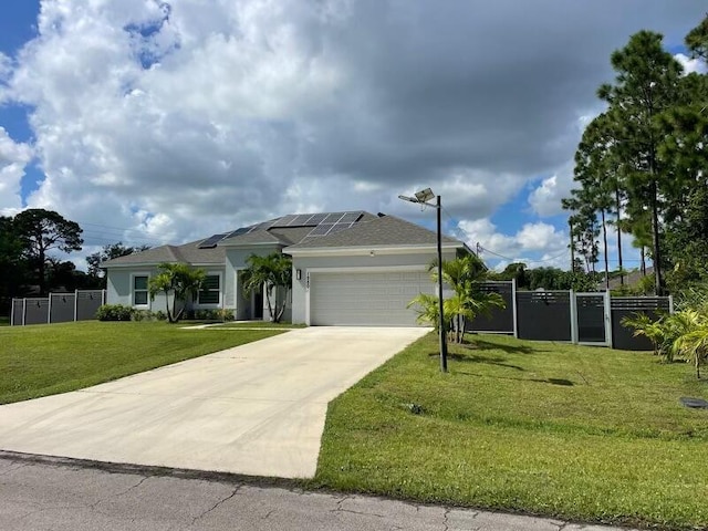 view of front of property featuring solar panels, a garage, and a front lawn