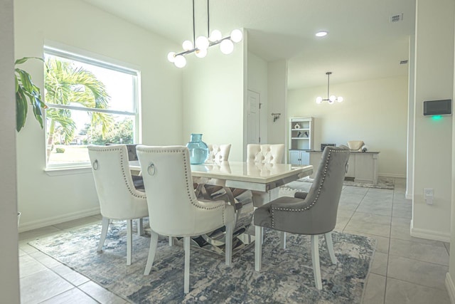 tiled dining area featuring an inviting chandelier