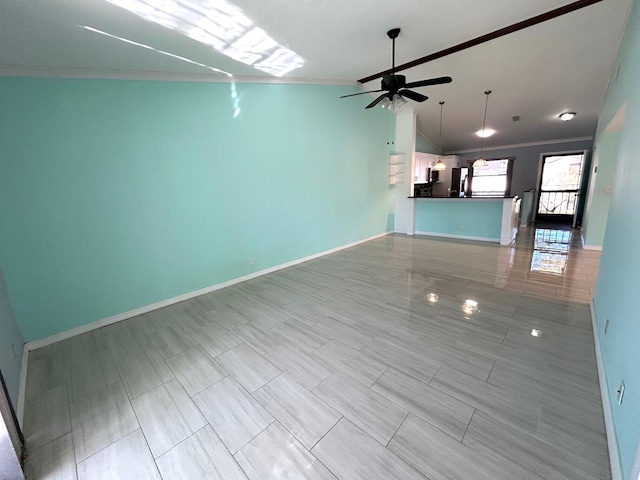 unfurnished living room featuring ceiling fan, crown molding, and vaulted ceiling