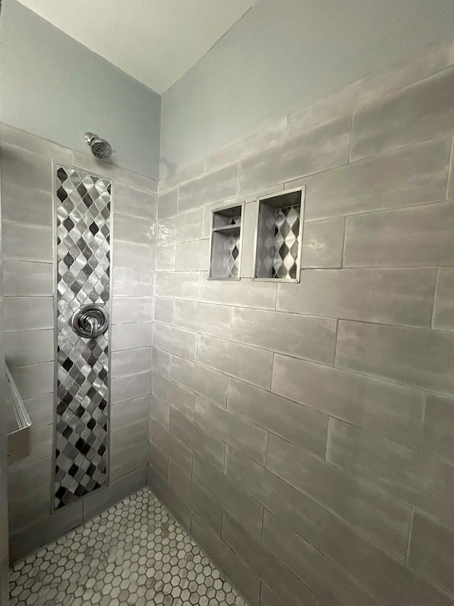 bathroom with a tile shower