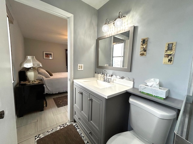 bathroom featuring tile patterned floors, vanity, and toilet