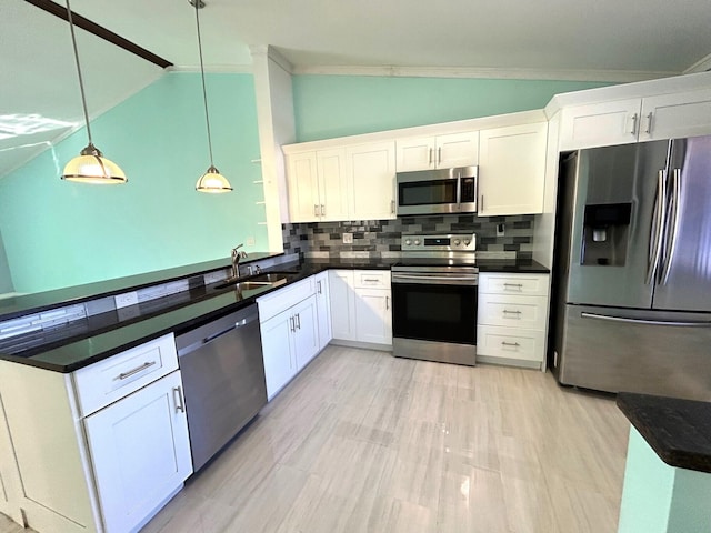 kitchen with white cabinetry, appliances with stainless steel finishes, and vaulted ceiling