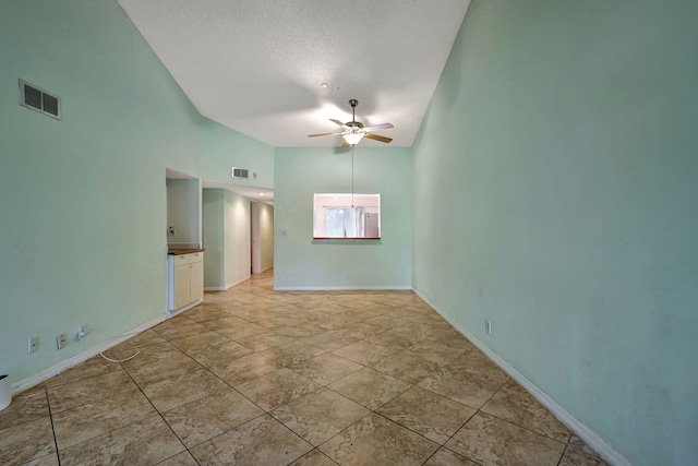 unfurnished room featuring ceiling fan, high vaulted ceiling, a textured ceiling, and light tile patterned floors