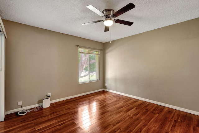 spare room featuring a textured ceiling, ceiling fan, and dark hardwood / wood-style flooring