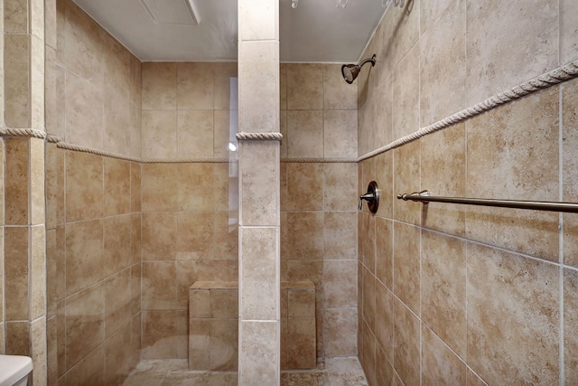 interior details featuring a tile shower