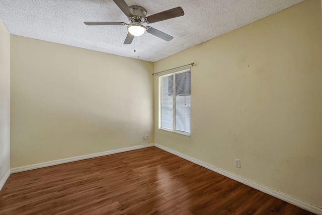 empty room with ceiling fan, a textured ceiling, and dark hardwood / wood-style floors