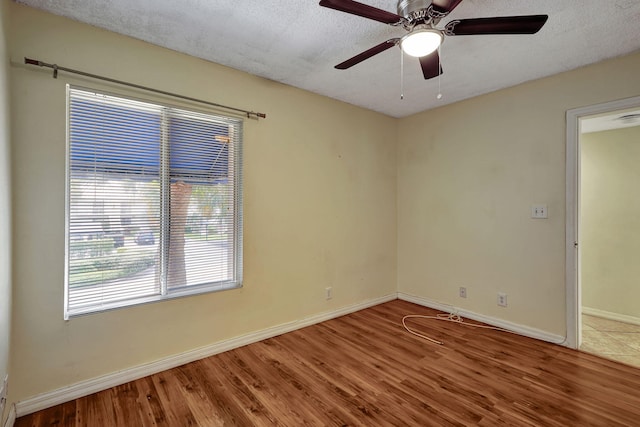 spare room featuring hardwood / wood-style floors, a textured ceiling, and ceiling fan