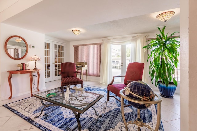 living area featuring french doors, a textured ceiling, and light tile patterned floors