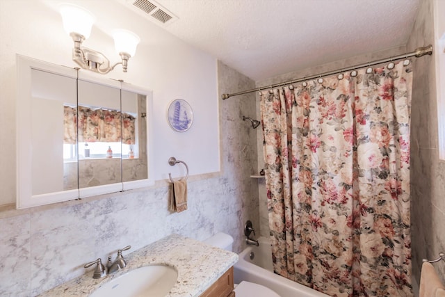 full bathroom featuring a textured ceiling, toilet, tile walls, and shower / bath combo with shower curtain