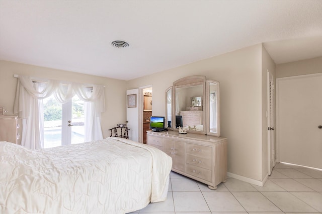 tiled bedroom with french doors and access to outside