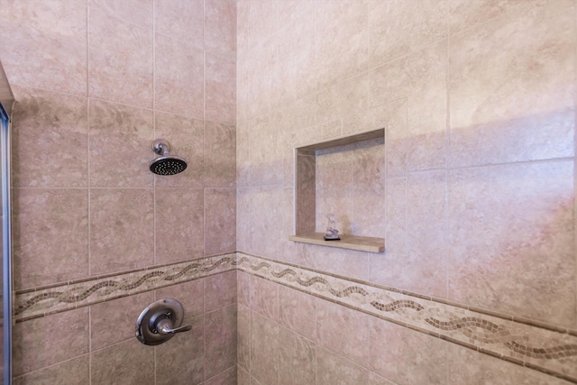 interior details featuring a tile shower