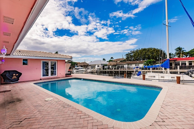 view of swimming pool with a patio and grilling area