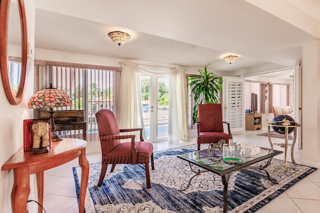 living area with light tile patterned floors and a textured ceiling