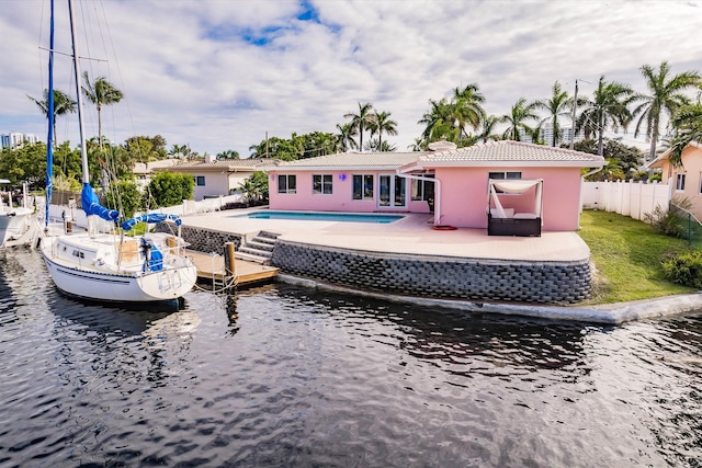 back of house with a water view and a patio area