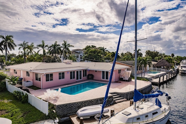 view of pool with a patio and a water view