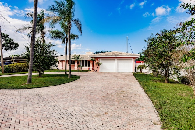 view of front of home featuring a garage and a front lawn