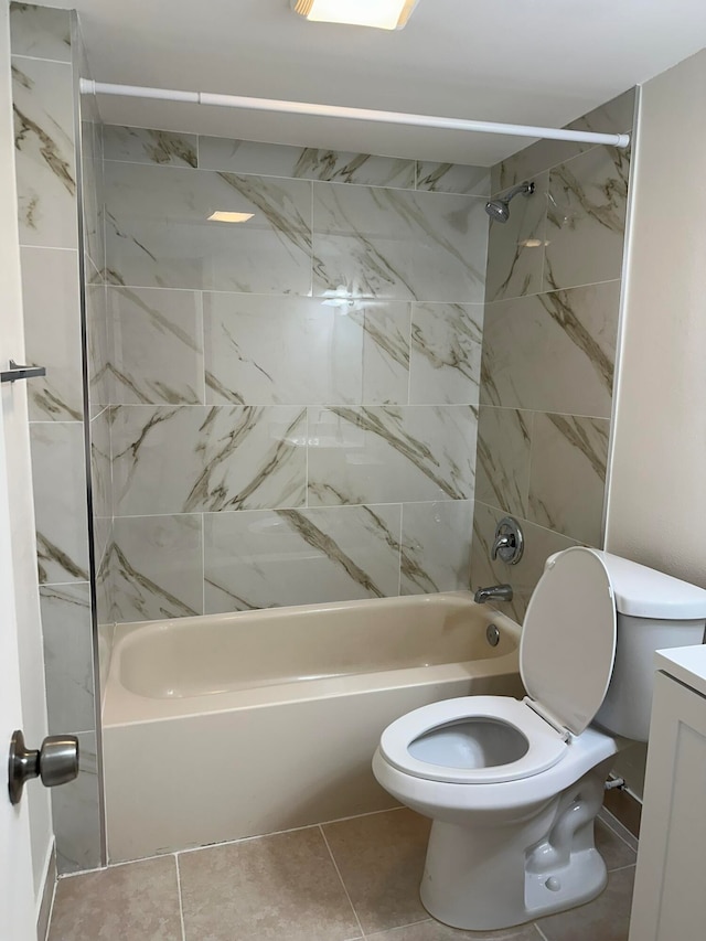 full bathroom featuring vanity, tiled shower / bath, toilet, and tile patterned flooring