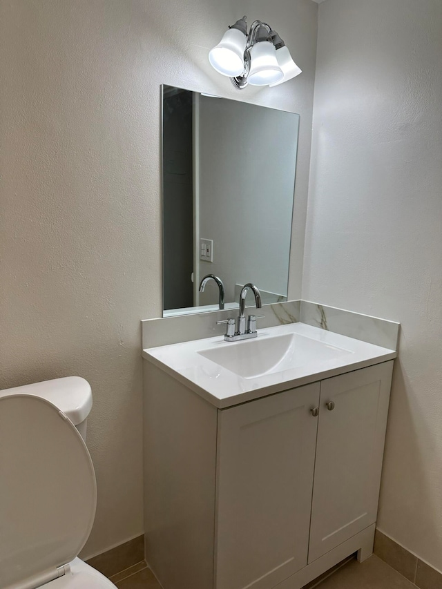 bathroom featuring vanity, toilet, and tile patterned floors