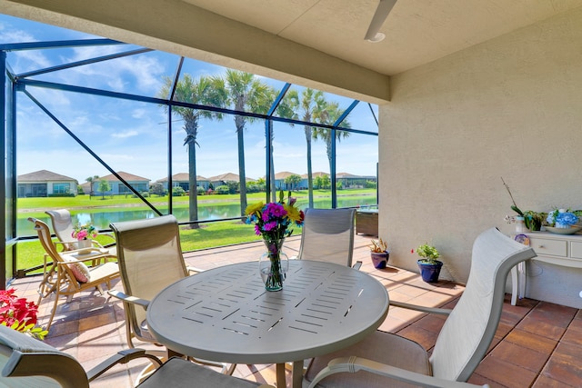 view of patio / terrace with a water view and glass enclosure