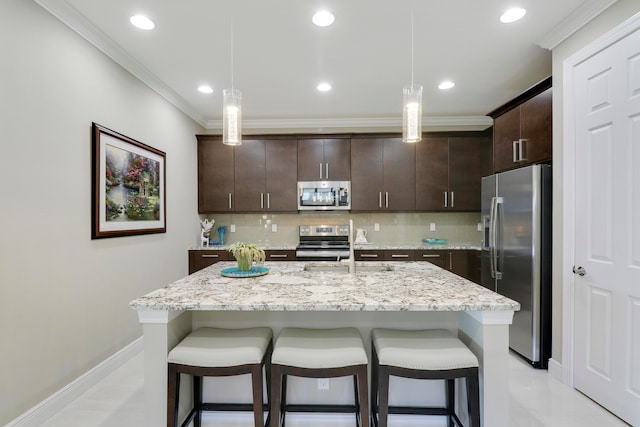 kitchen with decorative backsplash, hanging light fixtures, and stainless steel appliances