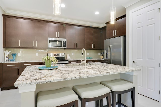 kitchen featuring decorative backsplash, decorative light fixtures, stainless steel appliances, and sink