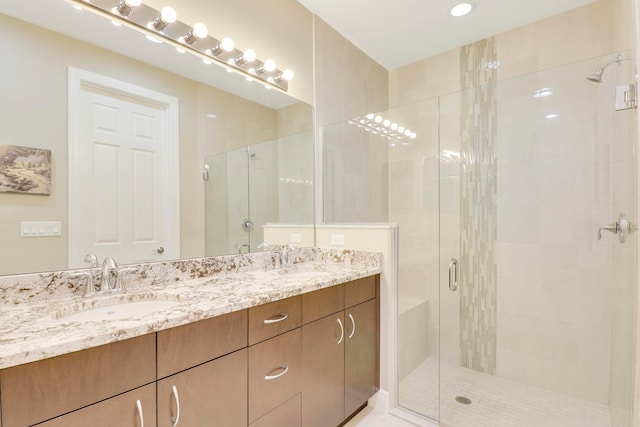 bathroom featuring vanity and an enclosed shower