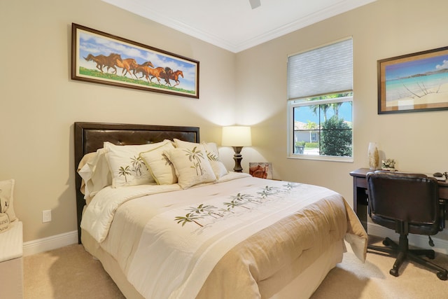 carpeted bedroom featuring crown molding and ceiling fan