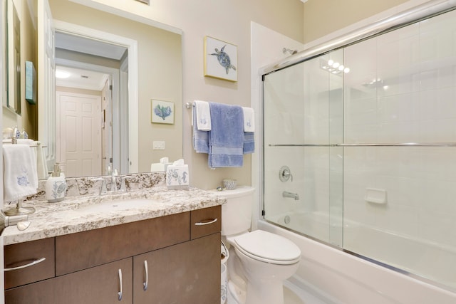 full bathroom with vanity, enclosed tub / shower combo, and toilet