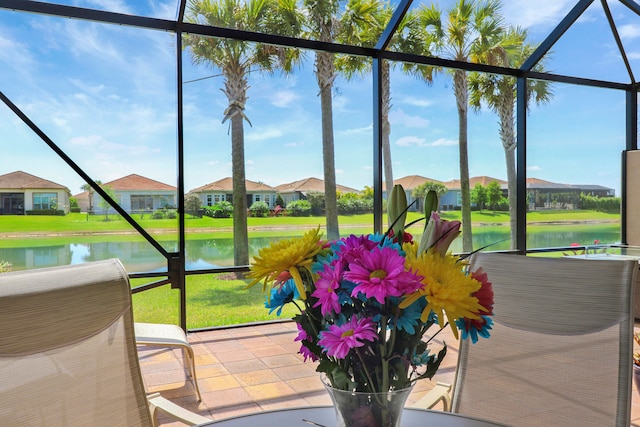 sunroom / solarium with a water view