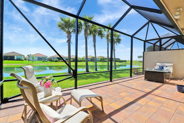 sunroom / solarium featuring a water view