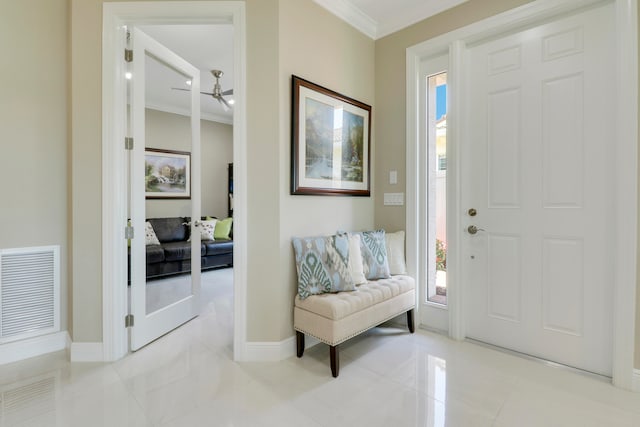 entrance foyer with crown molding and ceiling fan