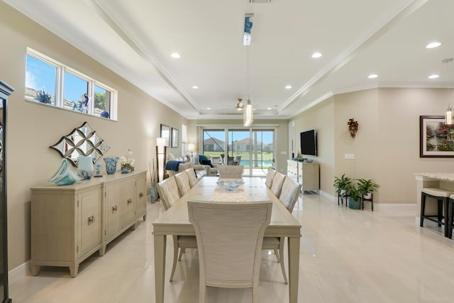 dining room with ceiling fan, ornamental molding, and light tile patterned floors