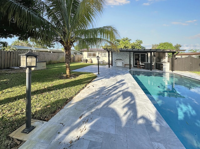 view of swimming pool featuring a yard, a patio, and grilling area