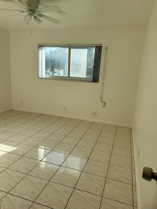 tiled empty room with ceiling fan