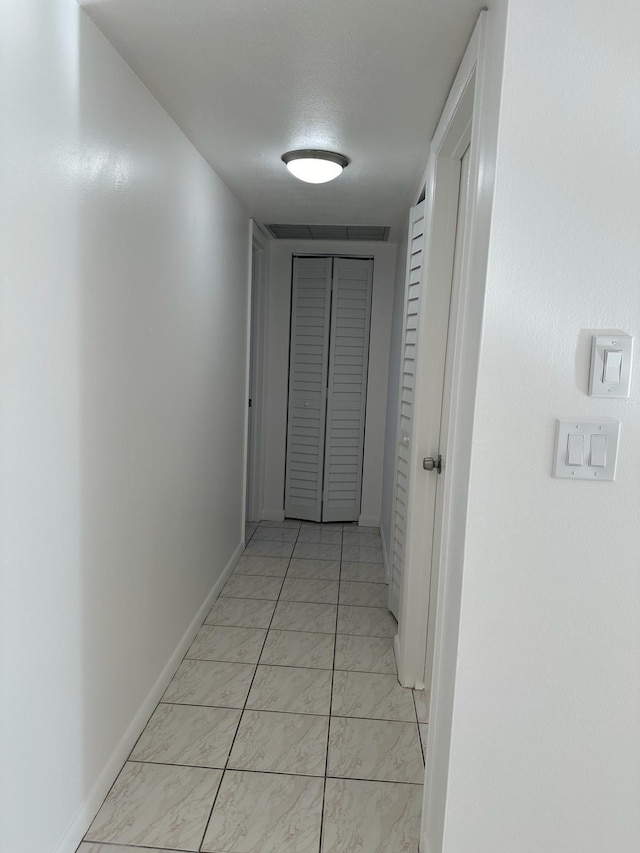 hallway with a textured ceiling