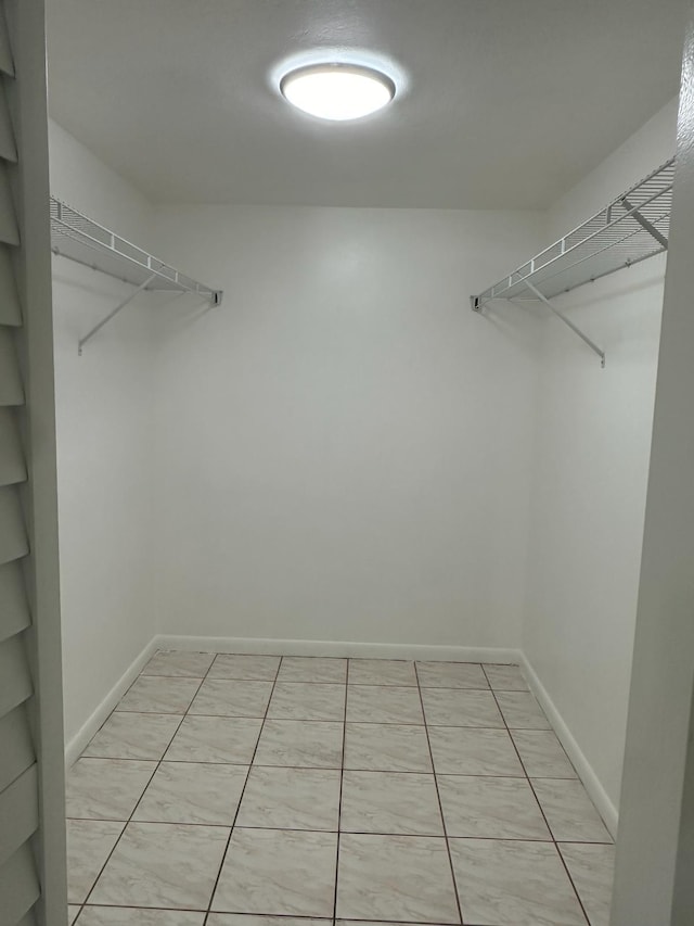 spacious closet featuring light tile patterned floors