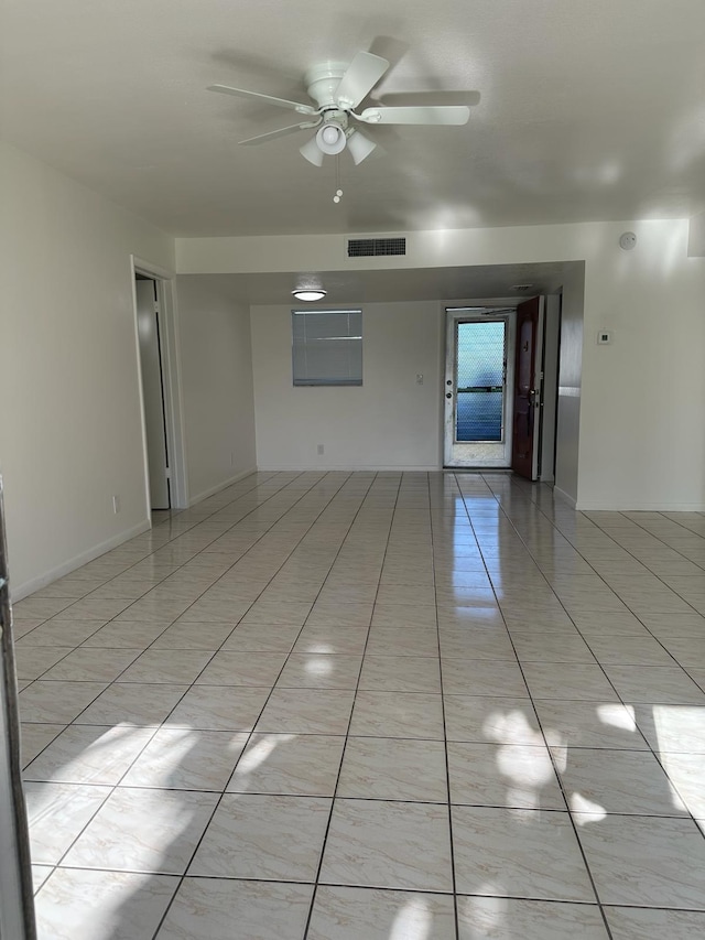 tiled empty room with ceiling fan